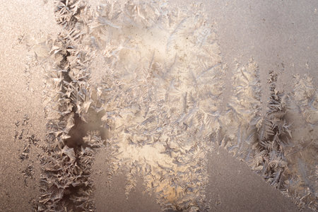 Cold winter morning ice flowers on glass, background with copy spaceの写真素材