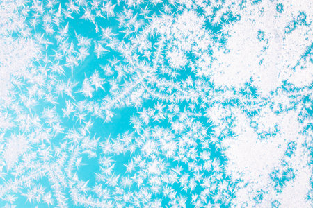 Cold winter morning ice flowers on glass, background with copy spaceの写真素材