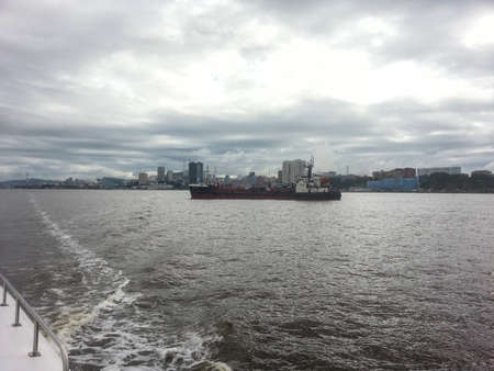 A view of a cargo ship sailing on the Chao Phraya River.の写真素材