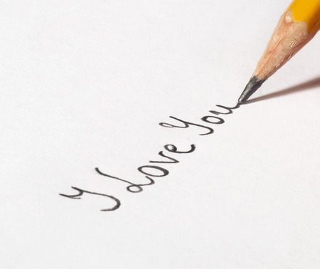 A hand writing "I love you"の写真素材