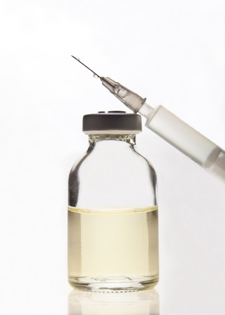 Glass Medicine Vial and Syringe on a white backgroundの写真素材