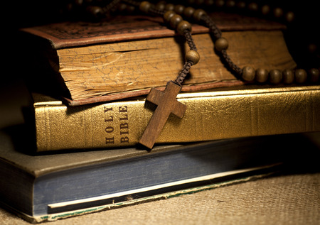 Old Holy Bibles and Wooden Rosary Beads.の写真素材