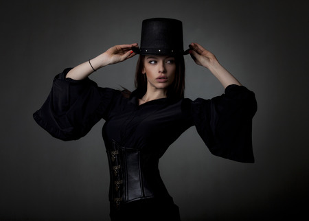 Beautiful brunette fashion model on a gray background.の写真素材