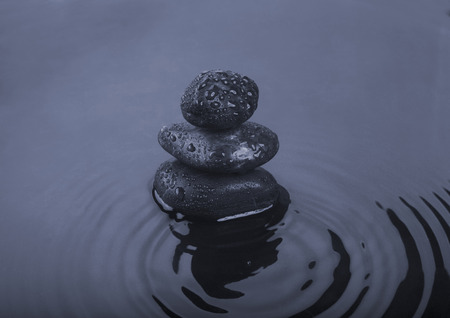 Background of a spa with black stones and dark water. Tinted image.の写真素材