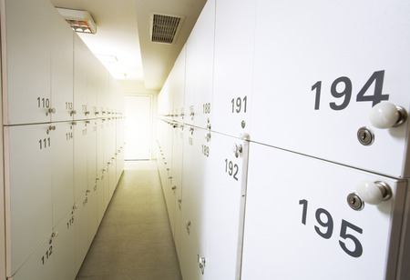 Two rows of white lockers with numbers.の写真素材