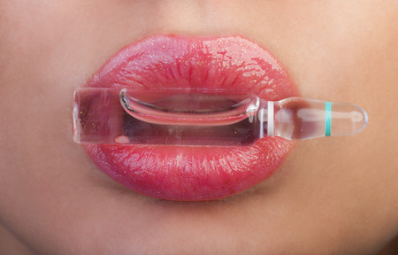 Lips and ampoule with botox, hyaluronic, collagen or HA liquid.の写真素材
