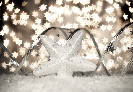 White Christmas star in the snow on a beautiful bokeh background.の写真素材