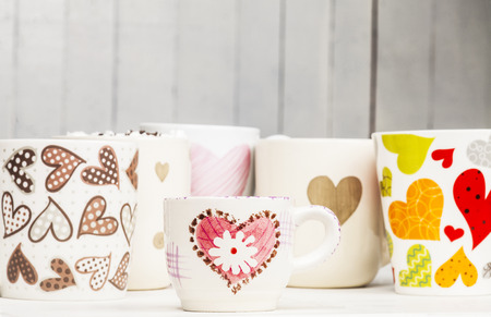 Lots of coffee in different cups with hearts. Copy space.の写真素材