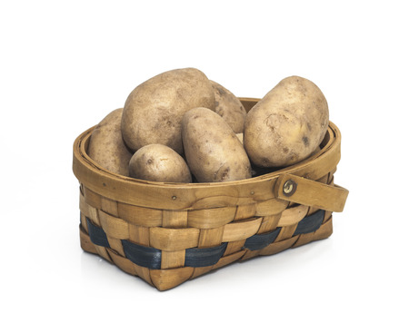 Potatoes in a Basket isolated on a white background.の写真素材