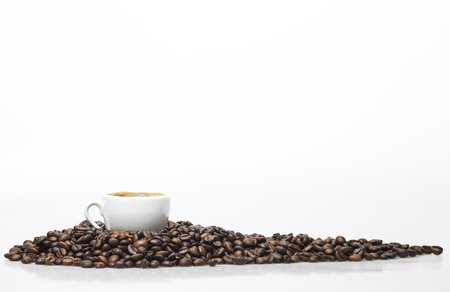 White coffee cup and coffee beans isolated on a white background.の写真素材