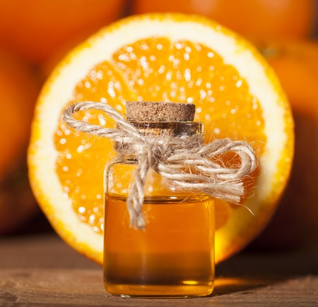 Bottle of essential oil from oranges on wooden background - alternative medicineの写真素材