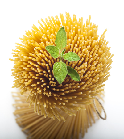 Bunch of raw spaghetti on white background, copy space, top view.の写真素材