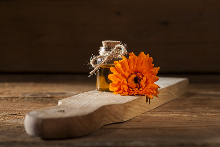 Essential oil made from marigold on rustic wooden backgroundの写真素材