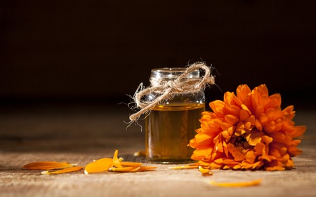 Essential oil made from marigold on rustic wooden backgroundの写真素材