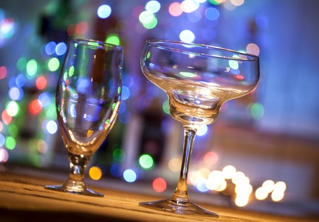 Empty glasses on table in night clubの写真素材