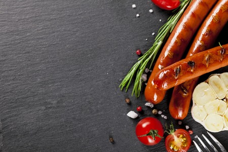Wiener Sausages with vegetables on black background. Top view.の写真素材