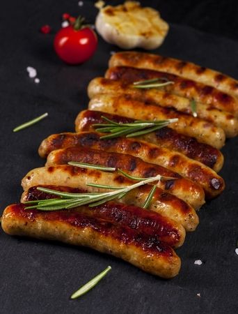 Wiener Sausages with vegetables on black background.の写真素材