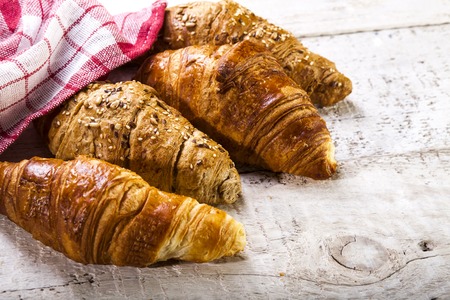 Croissants on a white wooden background with copy spaceの写真素材