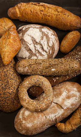 Assortment of baked goods on dark table. Top view, from above, flat lay.