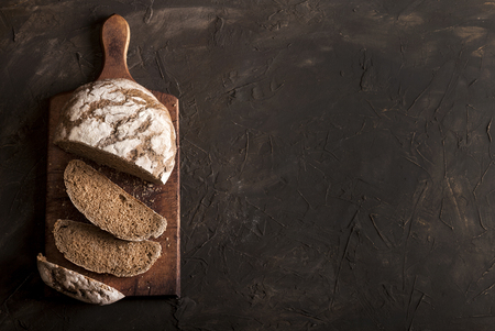 Sliced traditional bread on dark table with copy space. Top view.の写真素材