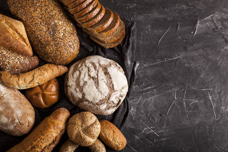 Assortment of baked goods on dark table with free copy space for text. Top view, from above, flat lay.の写真素材