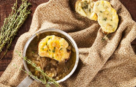 Onion soup with dried bread and cheddar cheeseの写真素材