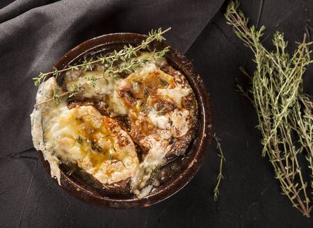 Onion soup with dried bread and cheddar cheeseの写真素材