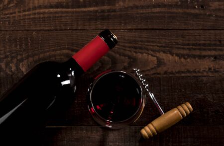 Red Wine in glass and buttle on wooden background with copy spaceの写真素材
