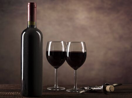 Red Wine in glasses and buttle with dust on dark background with copy spaceの写真素材