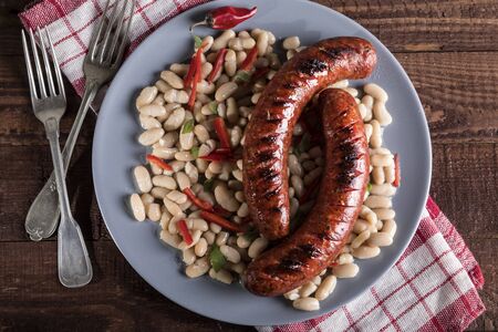 Beans with grilled sausage, traditional european homemade mealの写真素材