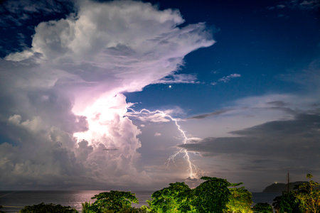 Amazing sunset over the stormy sea thunder and lightning in the backgroundの写真素材