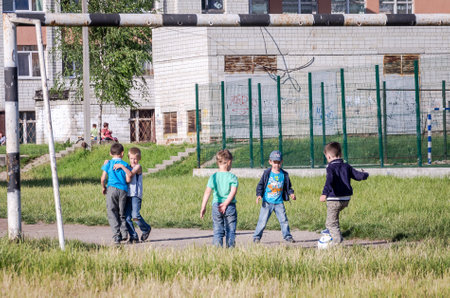 Lviv Ukraine June 2015: The team of children playing on the soccer field ball behind the goal in soccerのeditorial素材