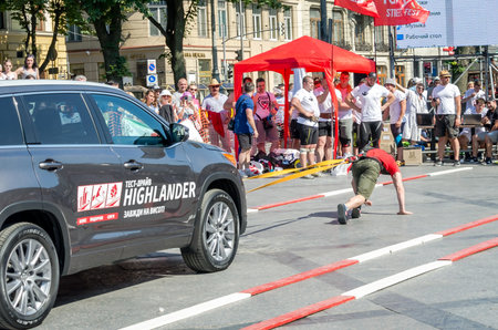 Lviv, Ukraine - July 2015: Yarych street Fest 2015. Strongman pulls Toyota Highlander