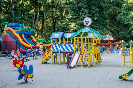 Lviv, Ukraine - 19 August 2015: Children's playground with swings and inflatable trampoline in amusement park where children play and their parents in a park in Lviv Ivan Frankoのeditorial素材