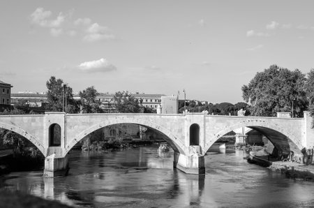 Quay of the river Tiber in Rome, Italy and the bridge across it, floating on the river excursion boat for touristsのeditorial素材