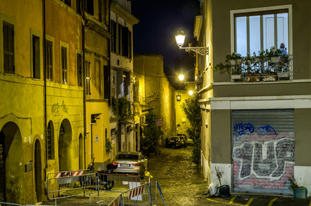 Roma, Italy - October 2015: Evening narrow streets of old Rome, Italy Night with parked cars on them and glowing lanterns and houses with windows that light burningのeditorial素材
