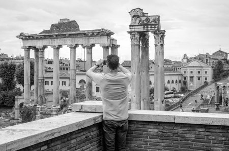 Roma, Italy - October 2015: Tourists walk and take pictures in the photo on the tour of the ancient ruins of the ancient imperial capital of the Roman Forum in Rome, Italyのeditorial素材