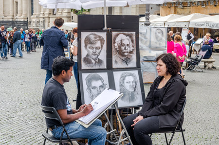 Roma, Italy - October 2015: A talented street artist draws a pencil on paper portrait of a woman sitting on a chair near the fountains of Piazza Navona in Rome, capital of Italyのeditorial素材
