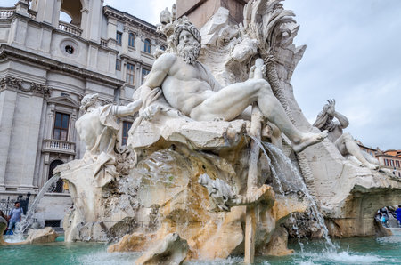 Roma, Italy - October 2015: Sculpture marble statue of a lion and a man on the fountain of the four rivers in Piazza Navona in Rome, capital of Italy, as well as tourists strolling on tripsのeditorial素材