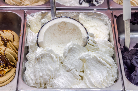 Showcase in the cafe with an Italian gelato ice cream and waffle cup with chocolate and icingの写真素材