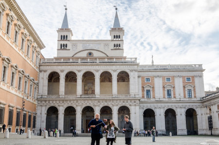 Roma, Italy - October 2015: Tourists walking on the tour and photographed landmark in the background with a stick for self in Basilica di San Giovanni in Laterano in Rome, capital of Italyのeditorial素材