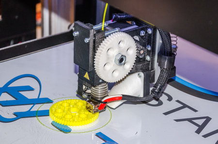 ROMA, ITALY - OCTOBER 2015: 3D printer produces plastic part being controlled by a computer program