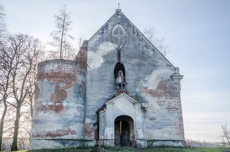 Ruins of old stone church from the ruined walls of which are treesの写真素材