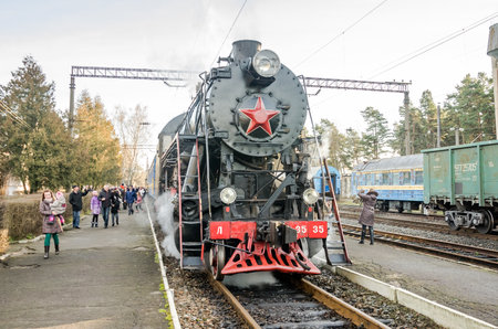 LVIV, UKRAINE - DECEMBER, 2015: Old iron black retro vintage Soviet steam locomotive with red star...