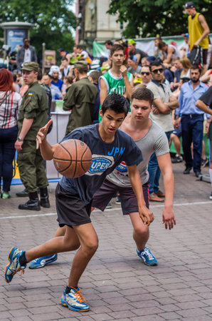 LVIV, UKRAINE - JUNE 2016: Basketball players are playing on the square in the street basketball, streetball jumping fighting forのeditorial素材