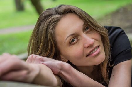 Portrait of a young charming girl with a seductive sexual look during a walk in Stryisky Park in...