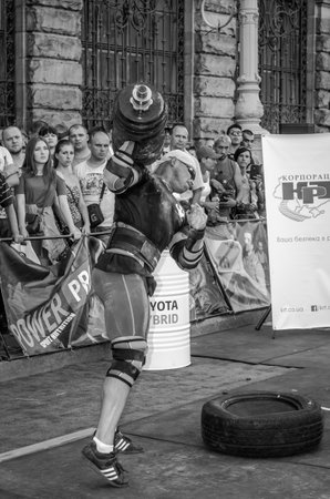 LVIV, UKRAINE - AUGUST 2015: Strong athlete athlete raises heavy weight on Strongmen gamesのeditorial素材