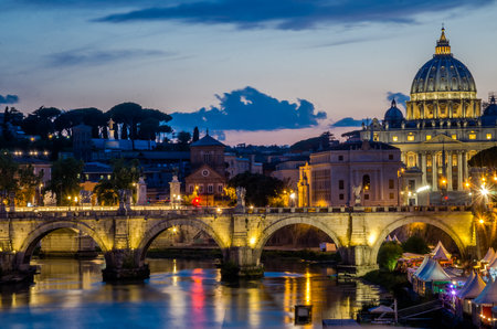 The bridge over the Tiber River and the Vatican dome at sunset in the evening in a summer day in Rome, Italyのeditorial素材