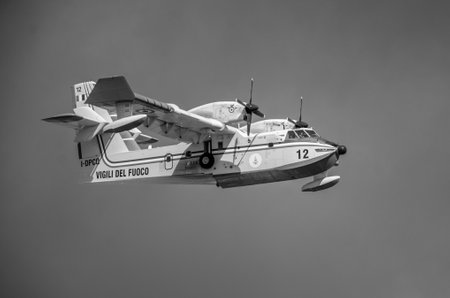 ROMA, ITALY - JULY 2017: Firefighting aircraft Bombardier CL-415 in an emergency situation, during a natural disaster, gathers water in the sea to extinguish a fire and eliminate catastrophe in Ostiaのeditorial素材
