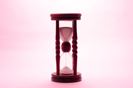 Old vintage retro wooden hourglass isolated on white background